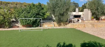 a soccer goal on a field of green grass at Gianni & Sophia airport house in Artemida