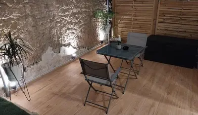 a table and chairs in a room with a couch at Rock Garden in Athens