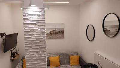 a living room with a couch and a mirror at Rock Garden in Athens