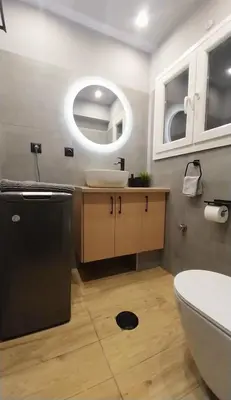 a bathroom with a sink and a toilet and a mirror at Rock Garden in Athens
