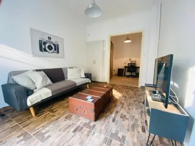 a living room with a couch and a flat screen tv at Koukaki comfortable apartment in Athens