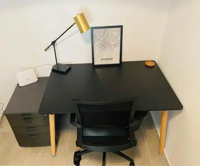 a black desk with a black chair and a lamp at Koukaki comfortable apartment in Athens