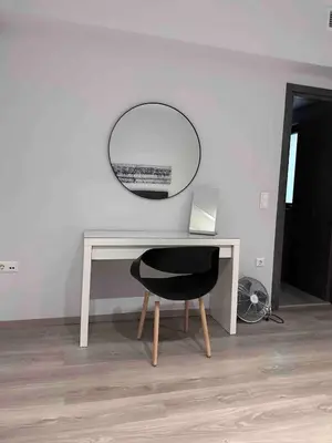 a desk with a black chair and a mirror at Apartment At Historic Center of Athens in Athens