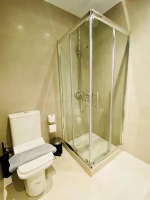 a bathroom with a shower and a white toilet at Apartment At Historic Center of Athens in Athens
