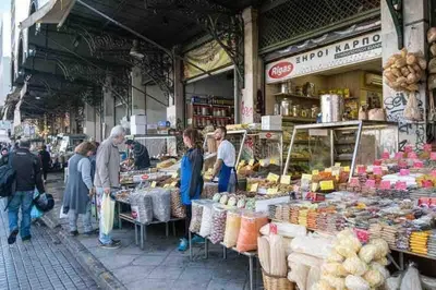 a group of people standing outside of a market at Apartment At Historic Center of Athens in Athens