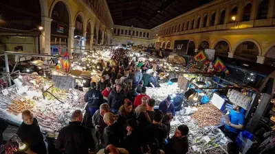 a crowd of people standing in a large room with fish at Apartment At Historic Center of Athens in Athens