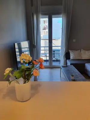 a living room with a vase with flowers on a table at Keramikos Stylish living in Athens