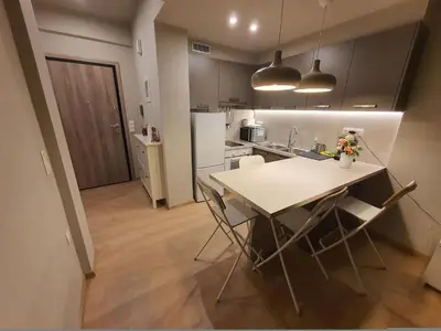 a kitchen with a table and chairs in a room at Keramikos Stylish living in Athens