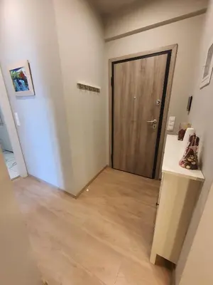 a hallway with a wooden door in a room at Keramikos Stylish living in Athens