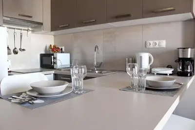 a kitchen with bowls and glasses on a counter at Keramikos Stylish living in Athens