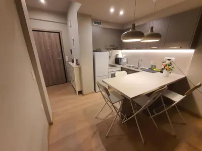 a kitchen with a table and chairs in a room at Keramikos Stylish living in Athens