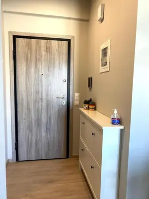 a door in a room with a dresser and a cabinet at Keramikos Stylish living in Athens