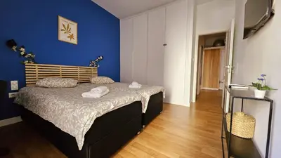 a bedroom with a bed with a blue wall at Heart of Faliro 2BR 5m Walk to Beach - Newly Renovated in Athens