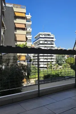 a view of a tall building from a balcony at Heart of Faliro 2BR 5m Walk to Beach - Newly Renovated in Athens