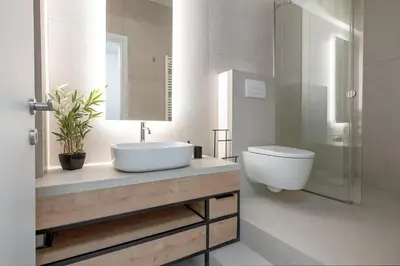a bathroom with a sink and a toilet at Leocharous 8 Suites in Athens