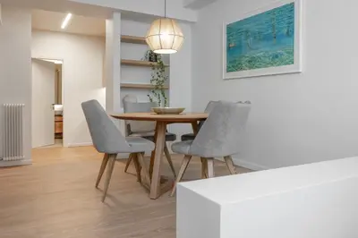 a dining room with a wooden table and chairs at Leocharous 8 Suites in Athens