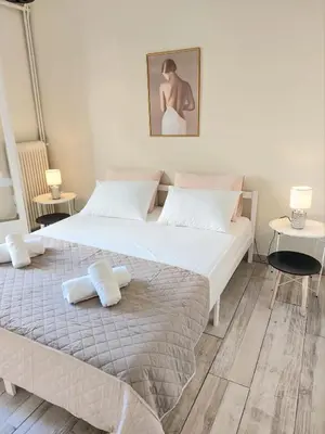 a bedroom with a large bed with towels on it at Double bed in a room dorm 5' from metro in Athens