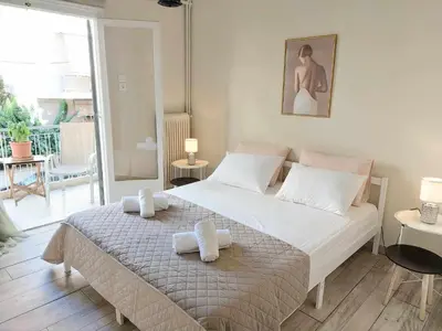 a bedroom with a large bed with towels on it at Double bed in a room dorm 5' from metro in Athens
