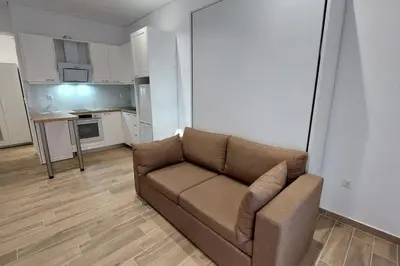 a living room with a couch and a kitchen at Central Lux Lining B in Athens