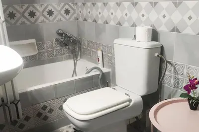 a bathroom with a toilet and a bath tub at Comfortably placed near the sea in Saronida