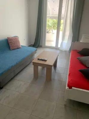 a living room with a couch and a coffee table at Comfortably placed near the sea in Saronida