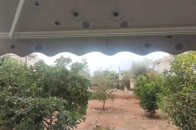 an outside view of a garden with trees and bushes at Comfortably placed near the sea in Saronida