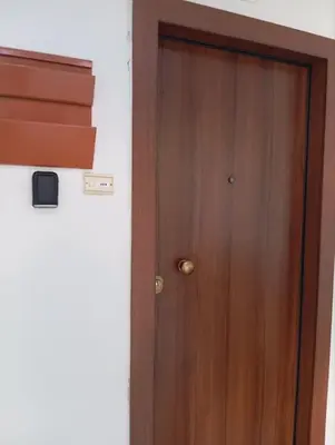 a wooden door in the corner of a room at Comfortably placed near the sea in Saronida