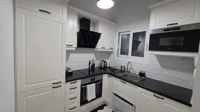 a white kitchen with a sink and a microwave at Central Lux Lining A in Athens
