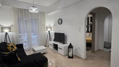 a living room with a couch and a tv at Central Lux Lining A in Athens