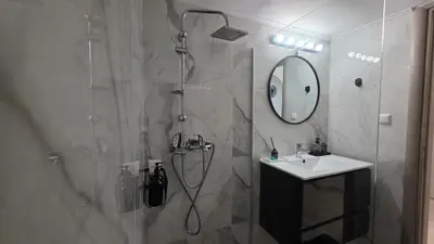 a bathroom with a shower and a sink at Central Lux Lining A in Athens