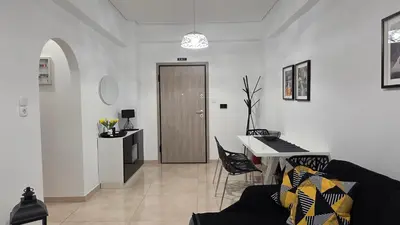a living room with a black couch and a table at Central Lux Lining A in Athens