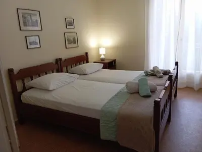 two twin beds in a bedroom with at ROOM 2 single beds 5' from metro in Athens