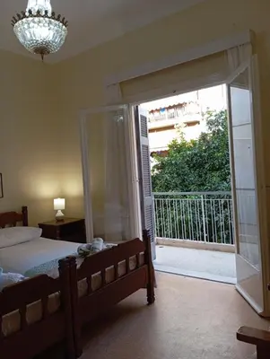 a bedroom with a bed and a large sliding glass door at ROOM 2 single beds 5' from metro in Athens