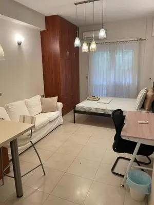 a living room with a couch and a bed at Μοντέρνος χώρος στο κέντρο της πόλης in Athens