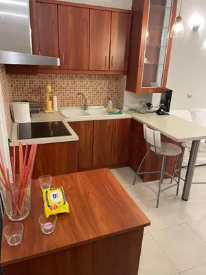 a kitchen with wooden cabinets and a counter top at Μοντέρνος χώρος στο κέντρο της πόλης in Athens