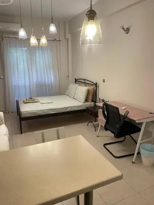 a living room with a bed and a table at Μοντέρνος χώρος στο κέντρο της πόλης in Athens