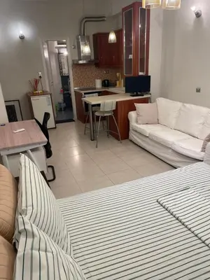 a living room with a couch and a kitchen at Μοντέρνος χώρος στο κέντρο της πόλης in Athens