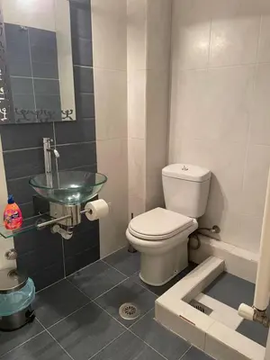 a bathroom with a toilet and a glass sink at Μοντέρνος χώρος στο κέντρο της πόλης in Athens