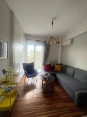 a living room with a couch and a table at Urban nest in Athens