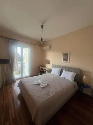 a bedroom with a large bed and a window at Urban nest in Athens