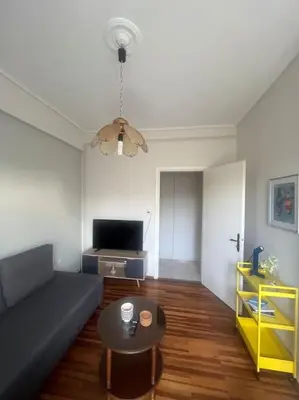 a living room with a couch and a table at Urban nest in Athens