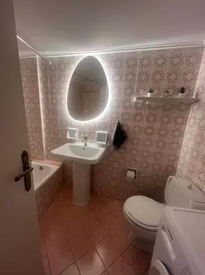 a bathroom with a sink toilet and a mirror at Urban nest in Athens