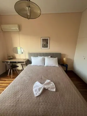 a white bow on a bed in a bedroom at Urban nest in Athens