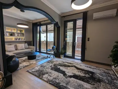 a living room with a couch and a table at Momentum Apartment in Athens