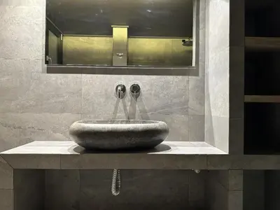 a sink with two faucets in a bathroom at Momentum Apartment in Athens