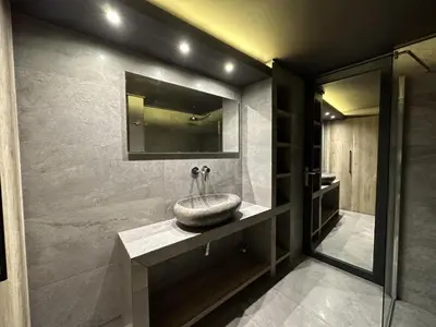 a bathroom with a sink and a mirror at Momentum Apartment in Athens