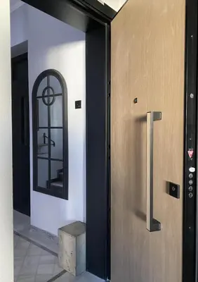 a door to a building with a mirror on it at Momentum Apartment in Athens