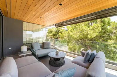 a living room with a couch and a large window at Glyfada Gem - 3BD apartment in Athens
