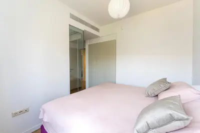 a bedroom with a white bed and a mirror at Glyfada Gem - 3BD apartment in Athens