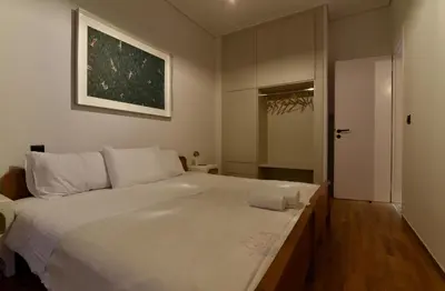 a bedroom with a large white bed and a closet at Fos Apartment - Ippokratous 2BDR Central Flat in Athens